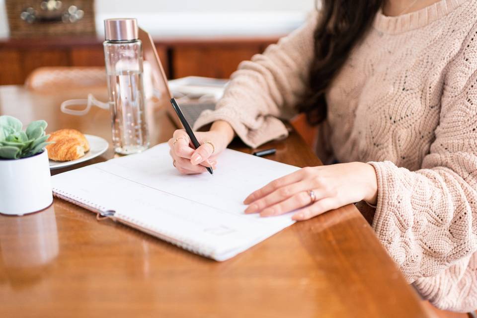 woman writing in notebook