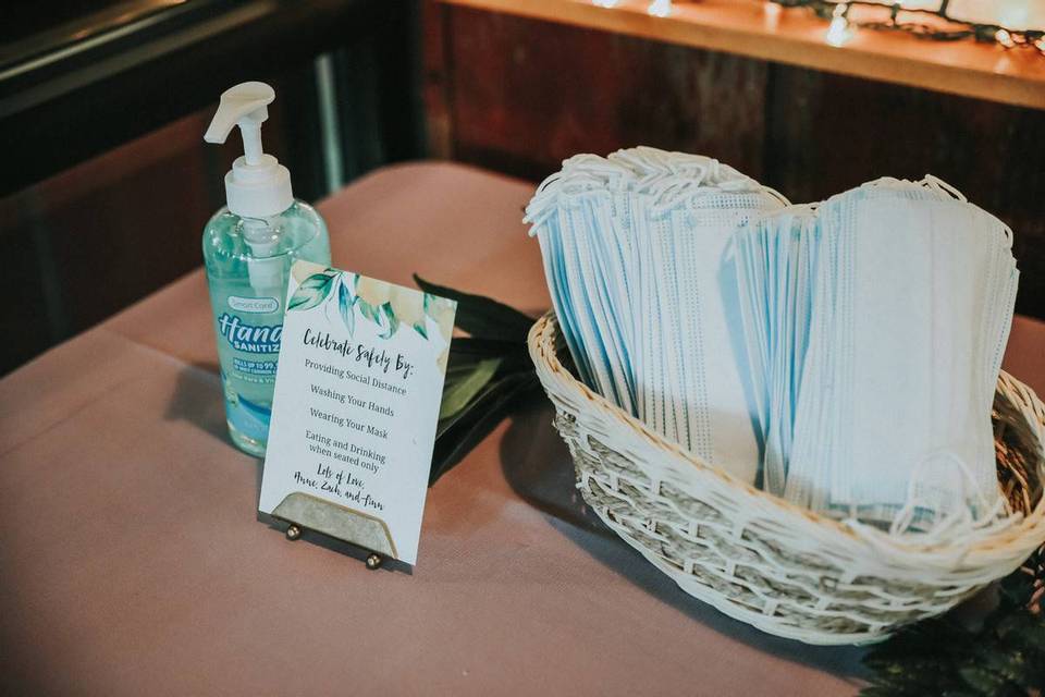 hand sanitizer and mask station at a wedding