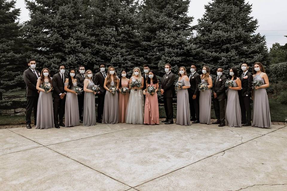 wedding party lined up wearing face masks