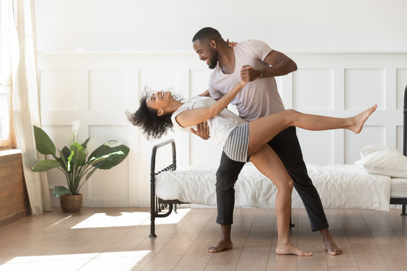 Couple dancing at home in their bedroom