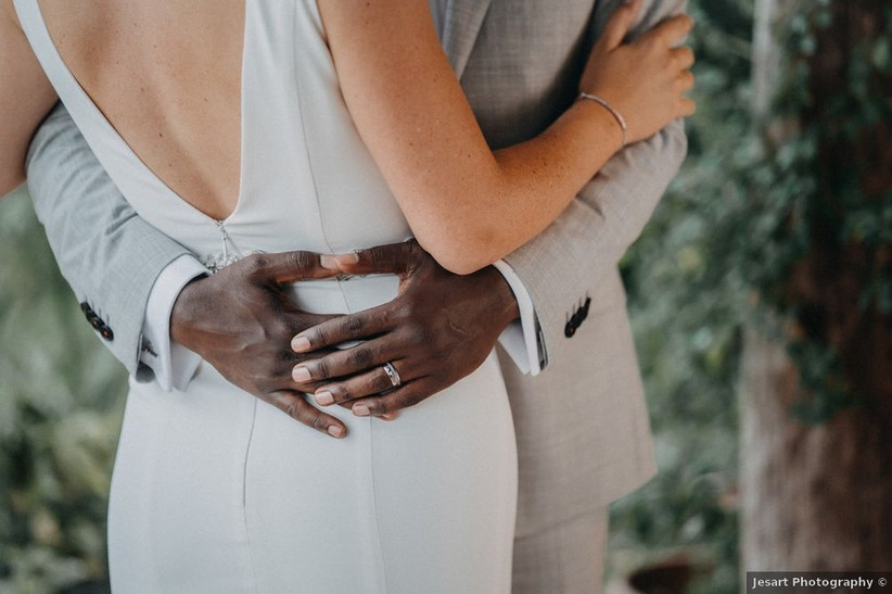 groom's hands around bride's waist