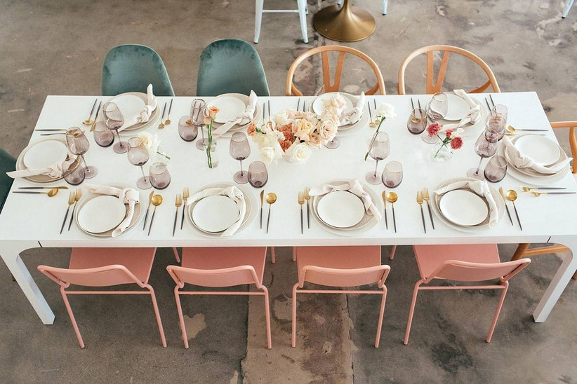 modern wedding reception table with colorful chairs