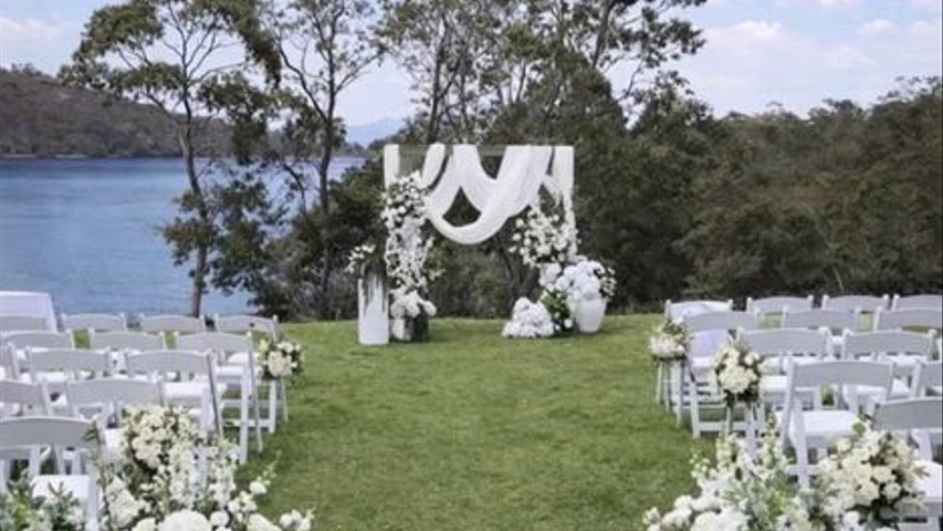 Elegant White Waterfront Arch with Floral Accents