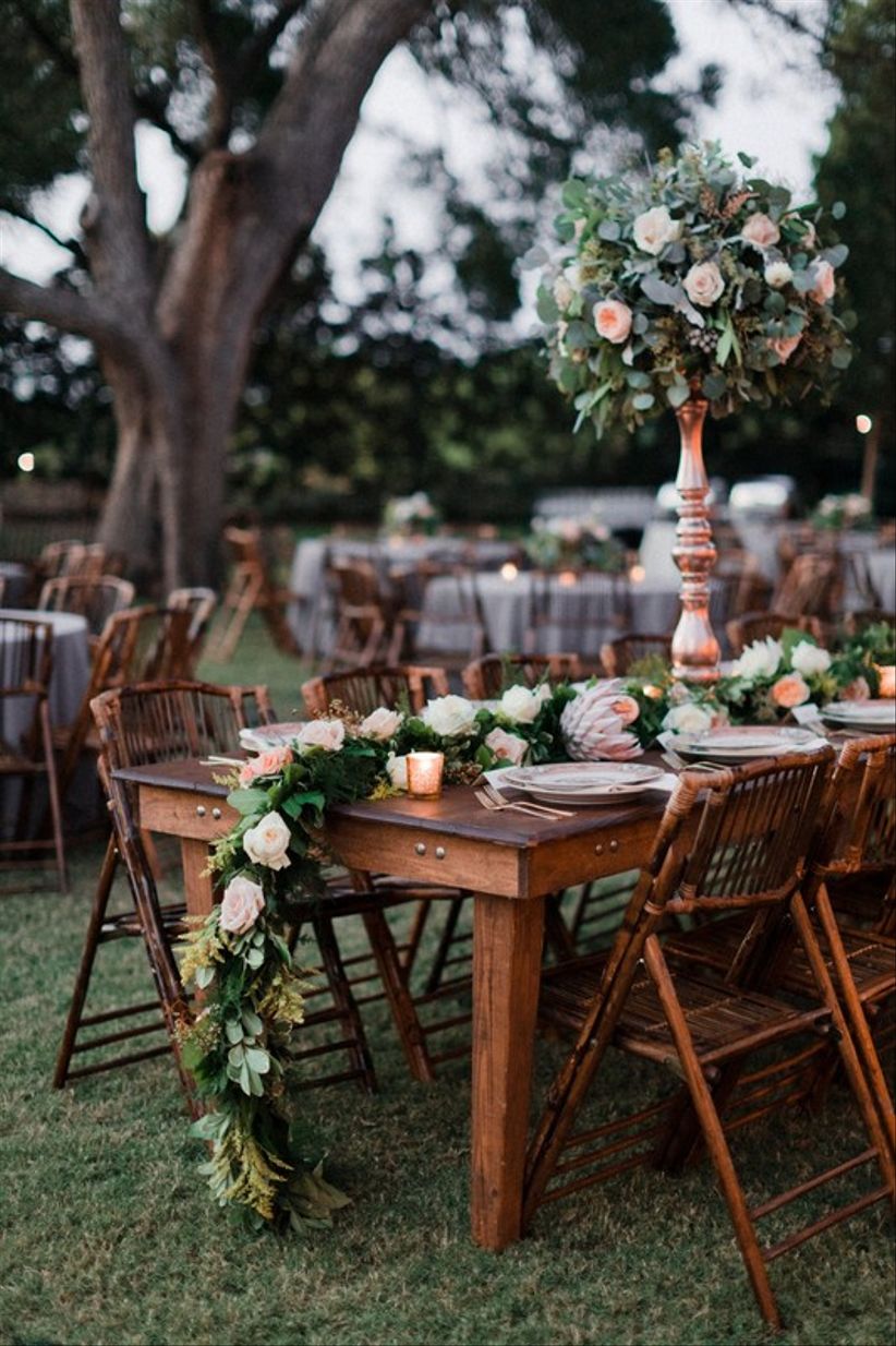 rattan chairs at outdoor wedding reception