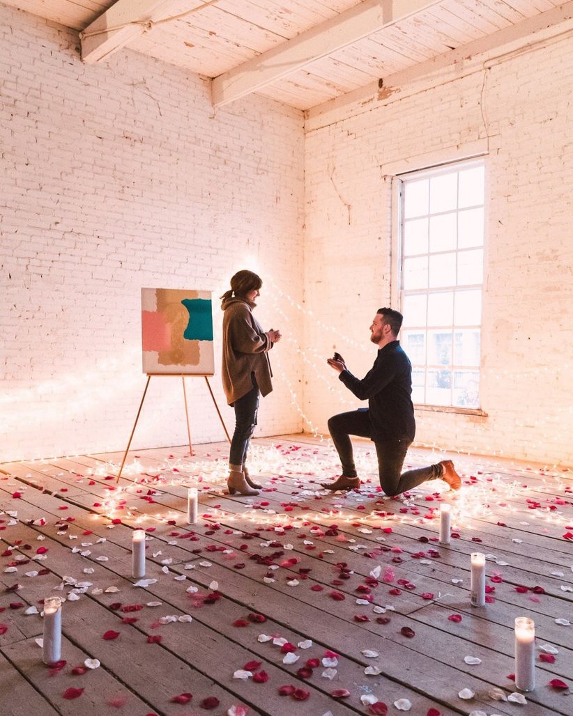 intimate proposal with candles and rose petals