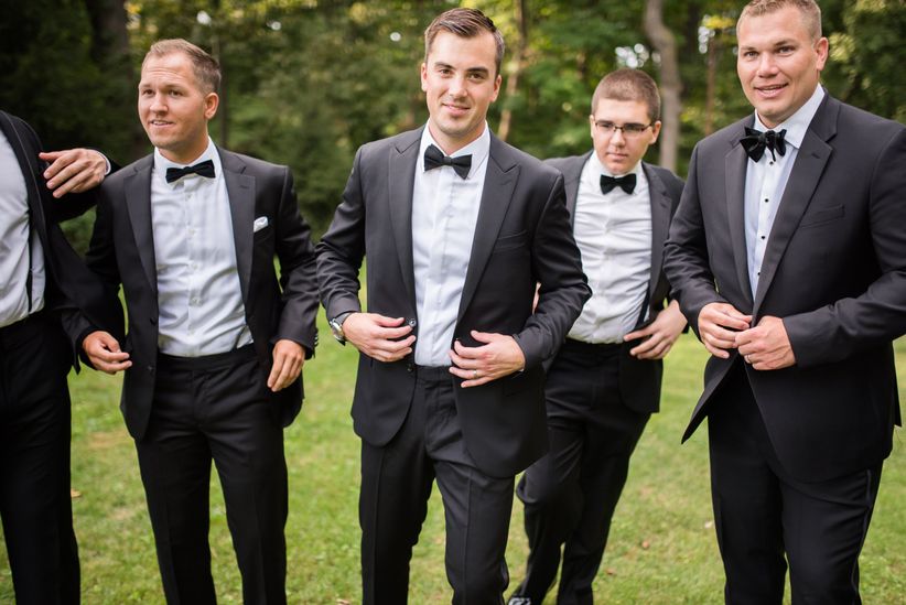 groom wears tux groomsmen wear suits