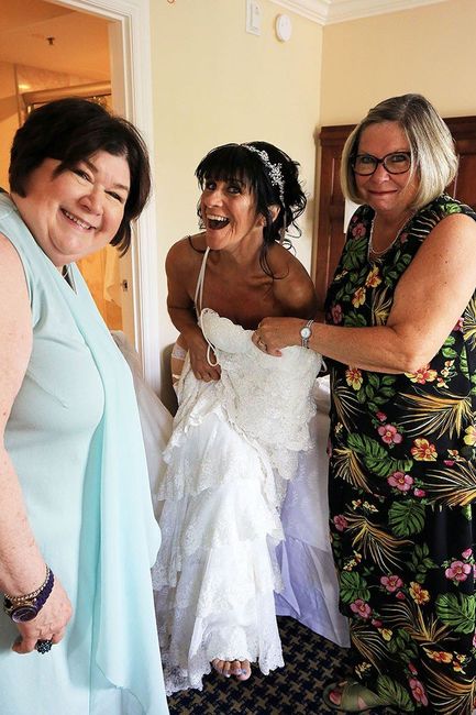 My sisters (who were also my officiant and MOB stand-in) helping me get dressed.