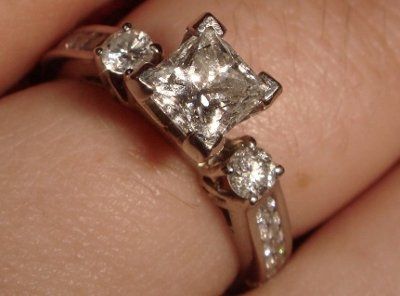 23 small diamonds, and one bigger diamond... I LOVE IT. Lets see some rings my fellow brides.