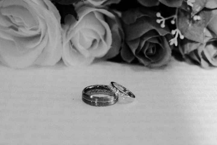 Another picture of our rings this one you can see the engraving of my husband's ring!