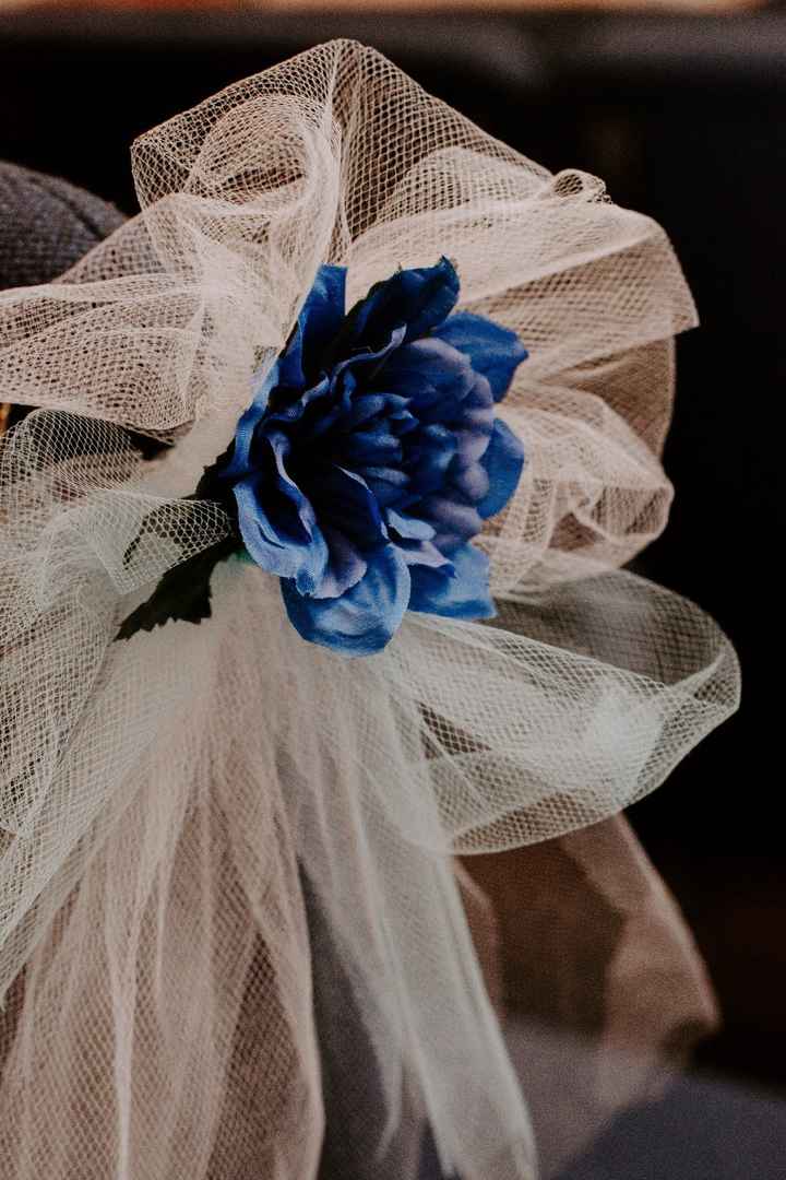 These decorations were on the chairs down the aisle. 