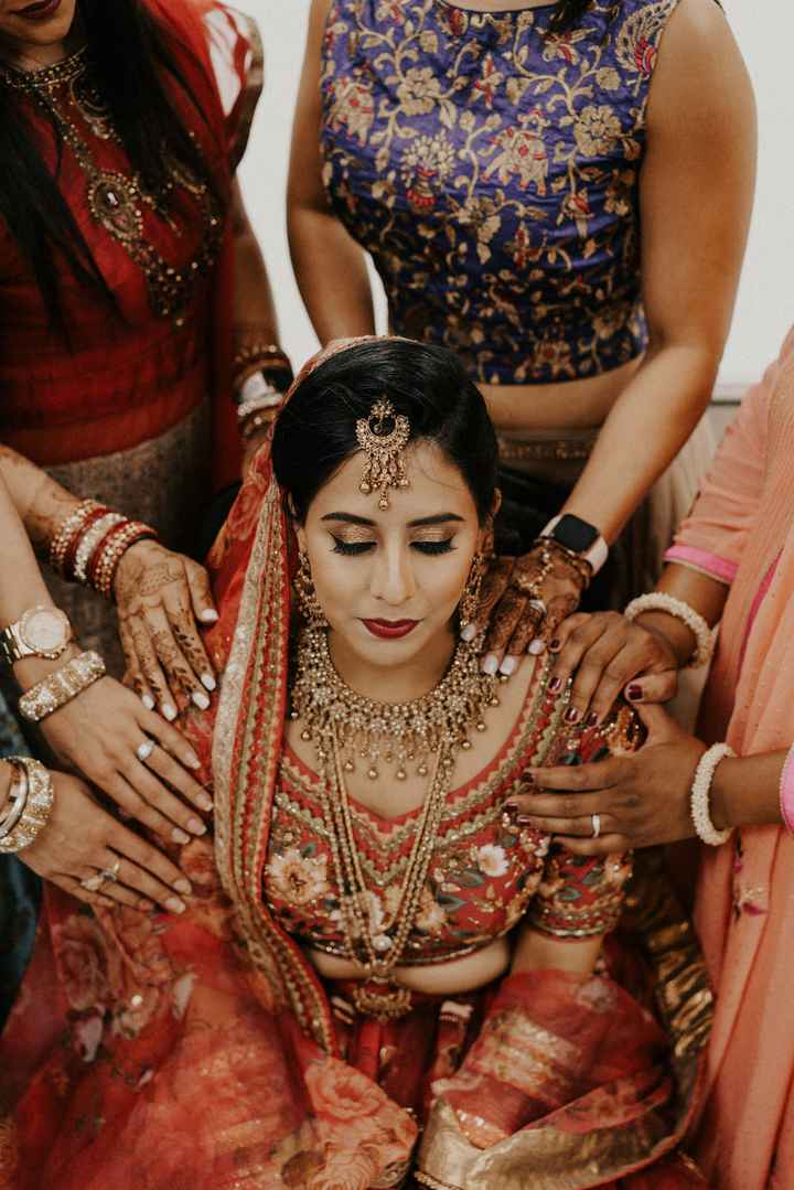 Pre ceremony image of bridesmaid praying over the bride. - 1