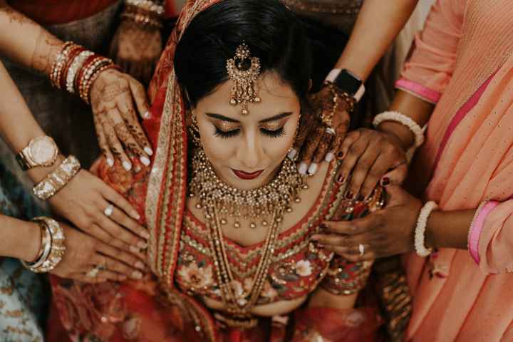 Pre ceremony image of bridesmaid praying over the bride. - 2