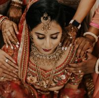 Pre ceremony image of bridesmaid praying over the bride. - 2