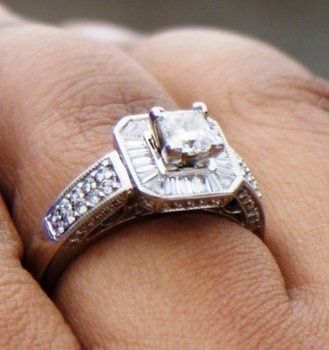 23 small diamonds, and one bigger diamond... I LOVE IT. Lets see some rings my fellow brides.