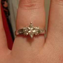 23 small diamonds, and one bigger diamond... I LOVE IT. Lets see some rings my fellow brides.