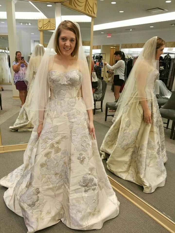 When your dress has flowers, what do you hold?