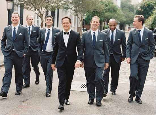 Groom wears tux groomsmen wear suits clearance