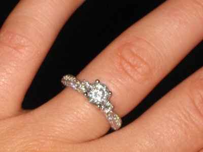 23 small diamonds, and one bigger diamond... I LOVE IT. Lets see some rings my fellow brides.