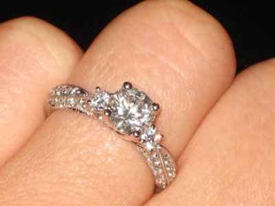 23 small diamonds, and one bigger diamond... I LOVE IT. Lets see some rings my fellow brides.