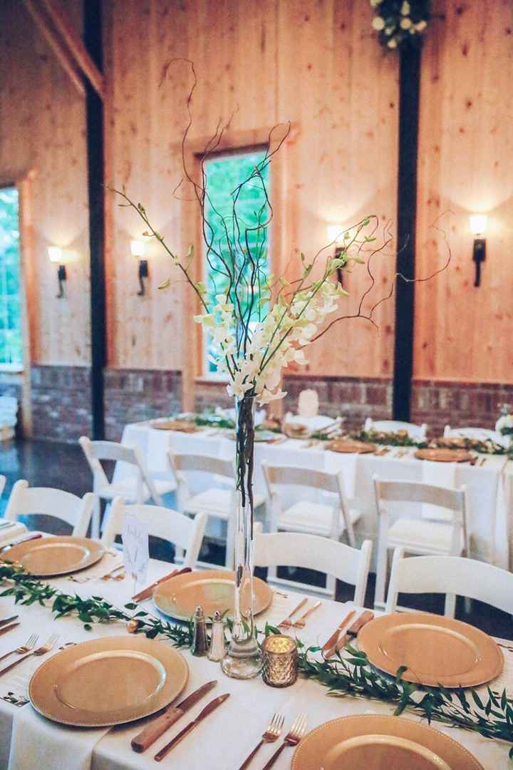We had a greenery runner, several tall & short centerpieces, candles, antlers & gold chargers on our