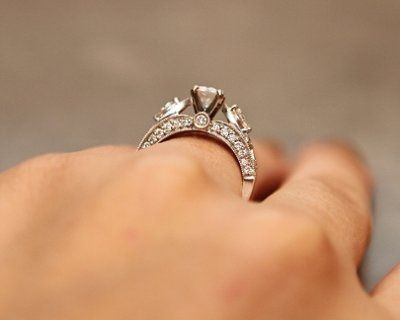 23 small diamonds, and one bigger diamond... I LOVE IT. Lets see some rings my fellow brides.