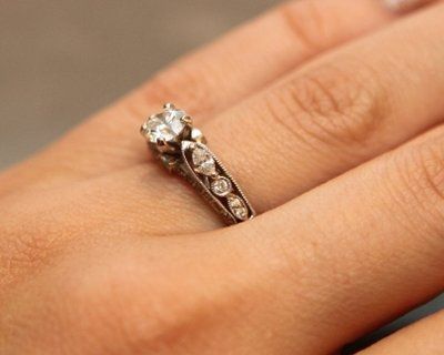 23 small diamonds, and one bigger diamond... I LOVE IT. Lets see some rings my fellow brides.