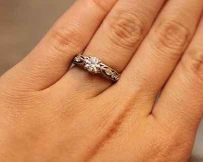 23 small diamonds, and one bigger diamond... I LOVE IT. Lets see some rings my fellow brides.