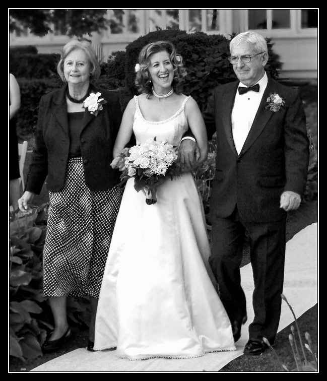 Both brothers walking me down the aisle, how do I hold my bouquet?
