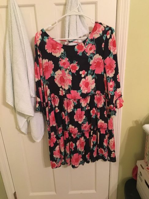 this is a dress that has pink flowers and green leaves