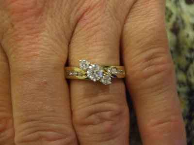 23 small diamonds, and one bigger diamond... I LOVE IT. Lets see some rings my fellow brides.