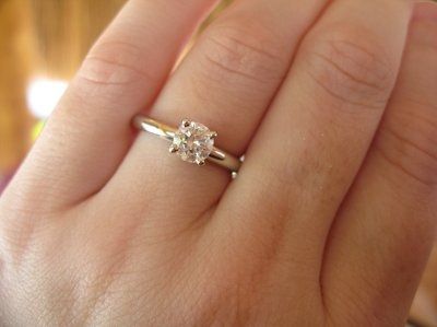 23 small diamonds, and one bigger diamond... I LOVE IT. Lets see some rings my fellow brides.