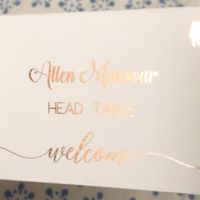 made foiled place cards and stuck them on wine corks to stand.