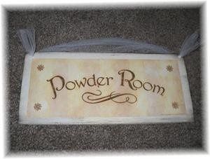 Bought powder room signs to cover venue uglies