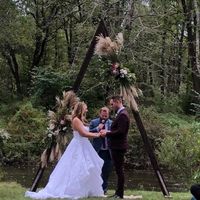 Our friend officiating under the arch my husband and a carpenter friend build