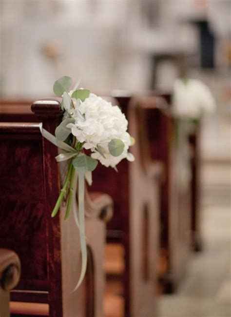 Small bouquets tied to the pews