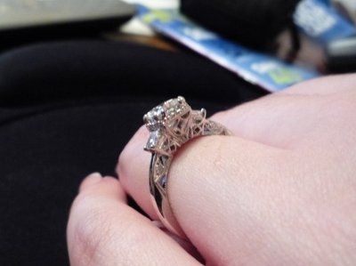 23 small diamonds, and one bigger diamond... I LOVE IT. Lets see some rings my fellow brides.