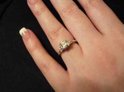 23 small diamonds, and one bigger diamond... I LOVE IT. Lets see some rings my fellow brides.