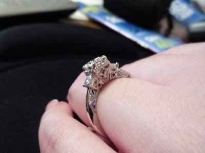 23 small diamonds, and one bigger diamond... I LOVE IT. Lets see some rings my fellow brides.