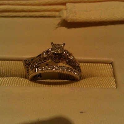 23 small diamonds, and one bigger diamond... I LOVE IT. Lets see some rings my fellow brides.
