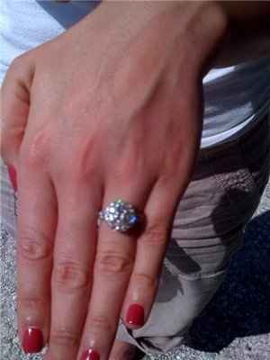 23 small diamonds, and one bigger diamond... I LOVE IT. Lets see some rings my fellow brides.