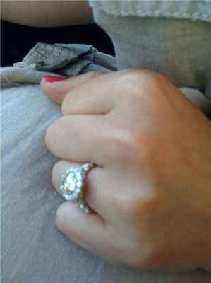 23 small diamonds, and one bigger diamond... I LOVE IT. Lets see some rings my fellow brides.
