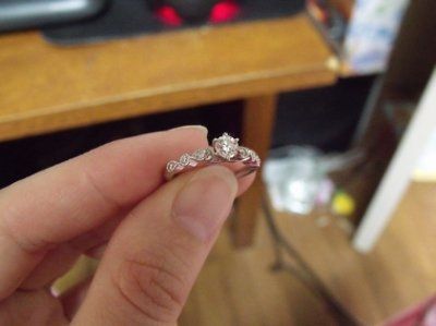 23 small diamonds, and one bigger diamond... I LOVE IT. Lets see some rings my fellow brides.