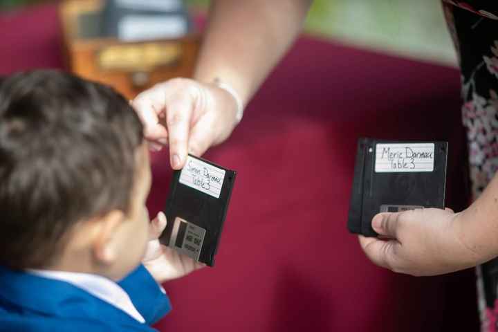 Floppy disk place cards in an old library card catalog drawer (I'm a book nerd, he's a movie and com