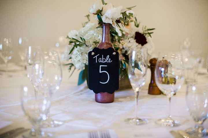 DIY wine bottle centerpiece - florist supplied florals