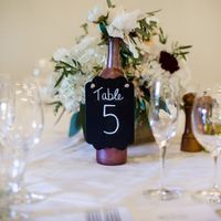 DIY wine bottle centerpiece - florist supplied florals