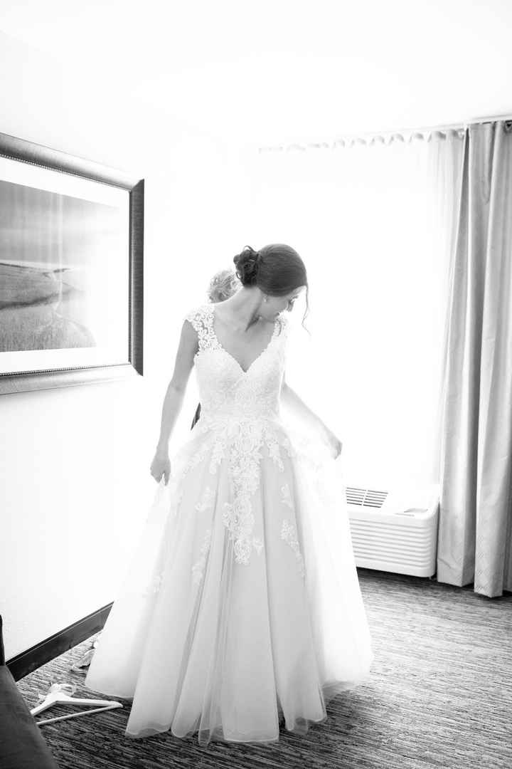 My mom helping me put on my dress