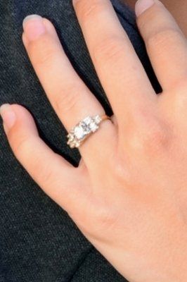 23 small diamonds, and one bigger diamond... I LOVE IT. Lets see some rings my fellow brides.