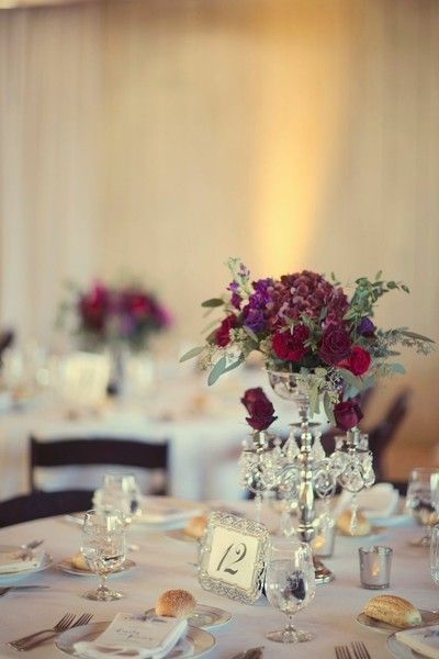 floral centerpiece inspo + silver decor + white/silver/light grey linen idea