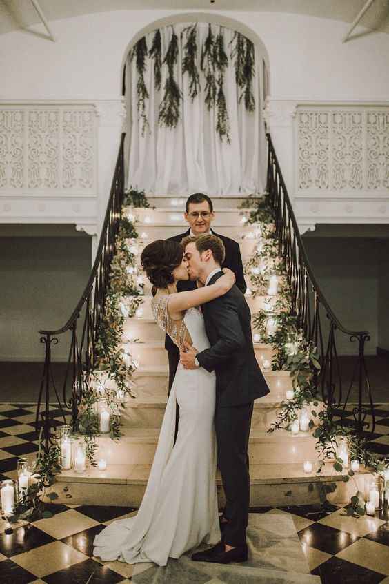 Stairs covered in greenery and candles as the ceremony backdrop