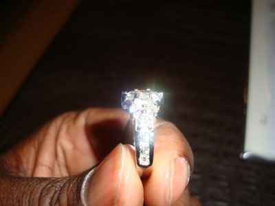 23 small diamonds, and one bigger diamond... I LOVE IT. Lets see some rings my fellow brides.